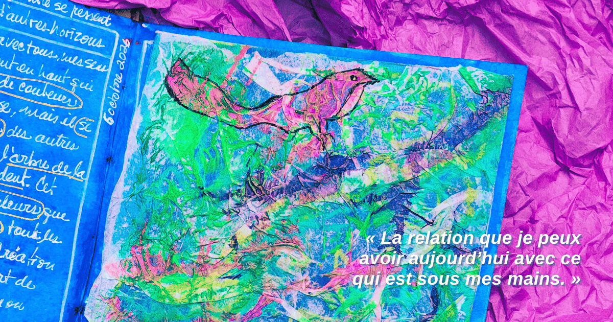 Photographie d’un Carnet de Louise ouvert sur une création intuitive au fond bleu, fait de ses mains et matière. Du papier de soie froissé dans des teintes de vert, rose et violet forme des plis et des creux. Dans la partie supérieure, un petit oiseau rose-mauve émerge de la matière. Un papier de soie mauve est glissé sous le carnet en haut à droite.